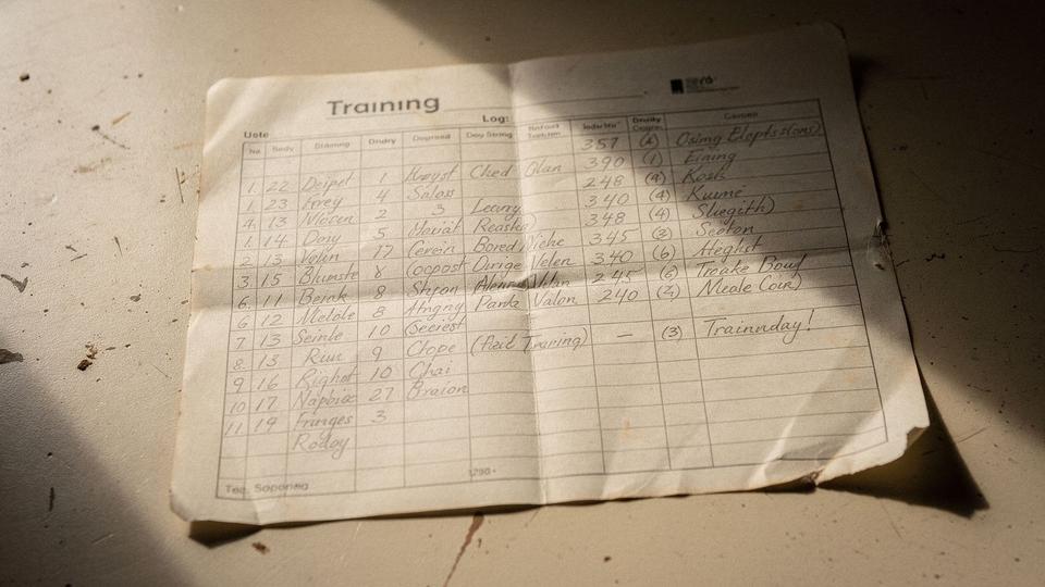 Close crop of a paper training log with handwritten session rows